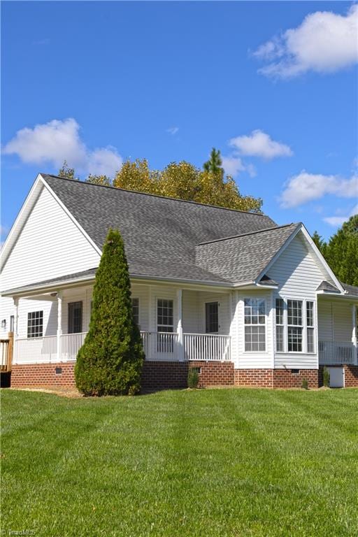 exterior space featuring a porch and a yard