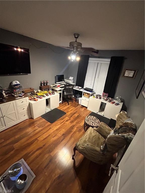 living room featuring hardwood / wood-style flooring and ceiling fan