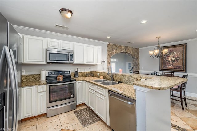 kitchen featuring sink, kitchen peninsula, decorative light fixtures, white cabinetry, and stainless steel appliances