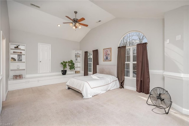 carpeted bedroom featuring ceiling fan and vaulted ceiling