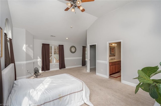 carpeted bedroom with ensuite bathroom, ceiling fan, and lofted ceiling