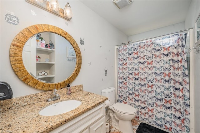 bathroom featuring vanity, toilet, and curtained shower