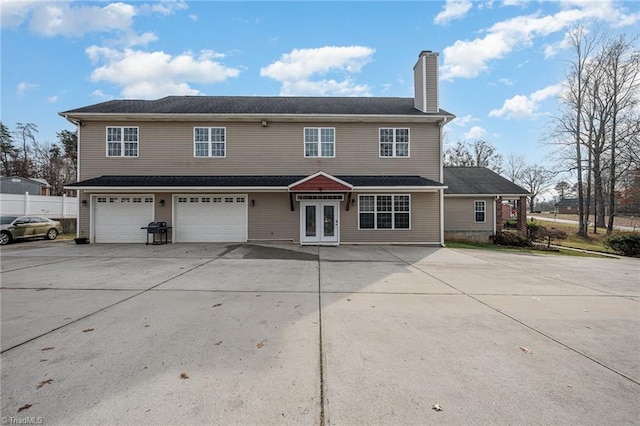 back of house with french doors and a garage