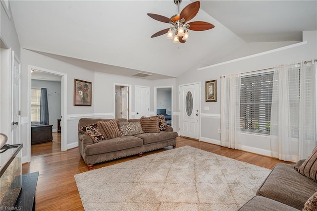 living room featuring light hardwood / wood-style floors, ceiling fan, and lofted ceiling