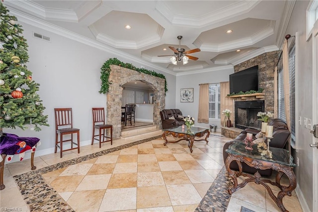 living room featuring coffered ceiling, crown molding, ceiling fan, light tile patterned floors, and a fireplace