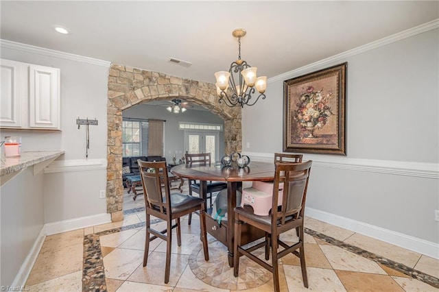 dining room featuring french doors, ceiling fan with notable chandelier, and ornamental molding