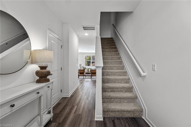 stairs with visible vents, wood finished floors, baseboards, and recessed lighting