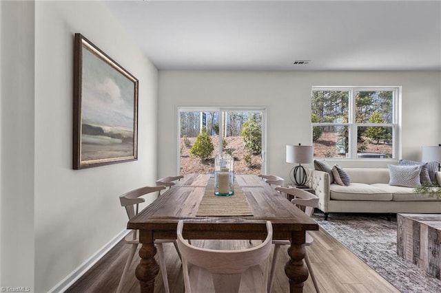 dining room featuring baseboards and wood finished floors