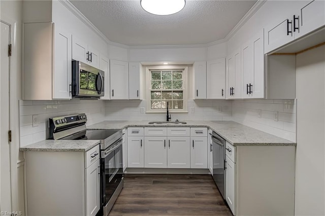 4814 Tower Rd, Greensboro, NC 27410 - kitchen featuring stainless steel appliances, a sink, a textured ceiling, light stone counters, and dark wood-style floors