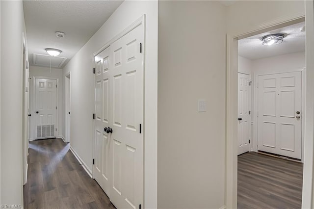 4814 Tower Rd, Greensboro, NC 27410 - hallway with attic access, dark wood-style flooring, and baseboards