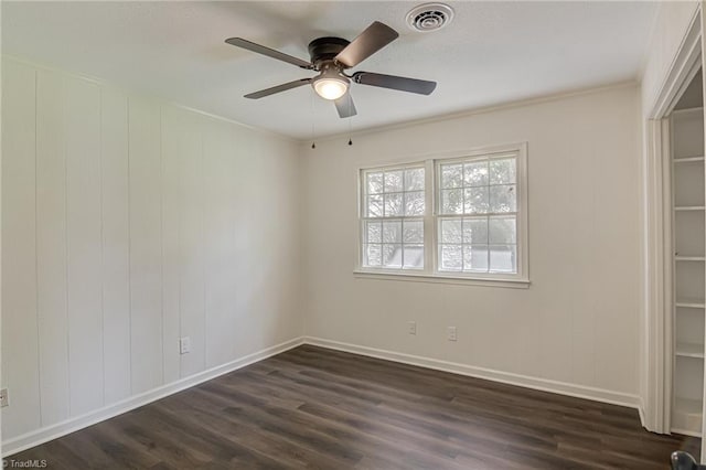 4814 Tower Rd, Greensboro, NC 27410 - spare room featuring dark wood finished floors, a ceiling fan, and baseboards