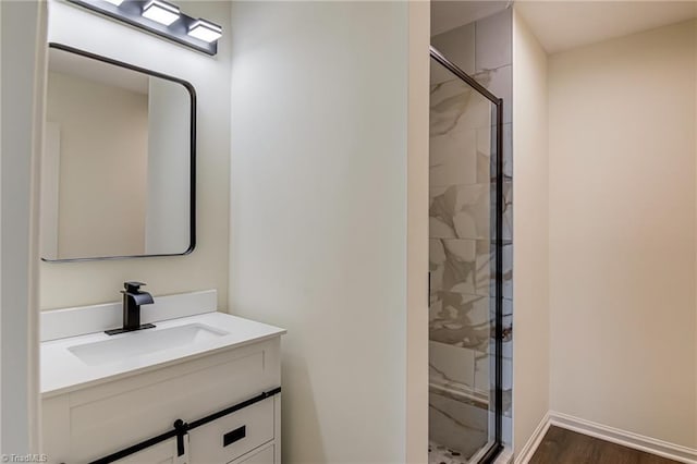 4814 Tower Rd, Greensboro, NC 27410 - full bathroom featuring a marble finish shower, vanity, wood finished floors, and baseboards