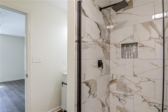 4814 Tower Rd, Greensboro, NC 27410 - bathroom featuring a marble finish shower, wood finished floors, vanity, and baseboards
