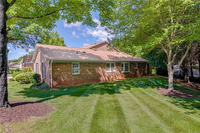 4814 Tower Rd, Greensboro, NC 27410 - rear view of house featuring brick siding and a yard