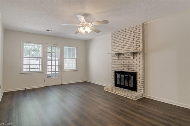 4814 Tower Rd, Greensboro, NC 27410 - unfurnished living room featuring a textured ceiling, dark wood-type flooring, a ceiling fan, a fireplace, and baseboards