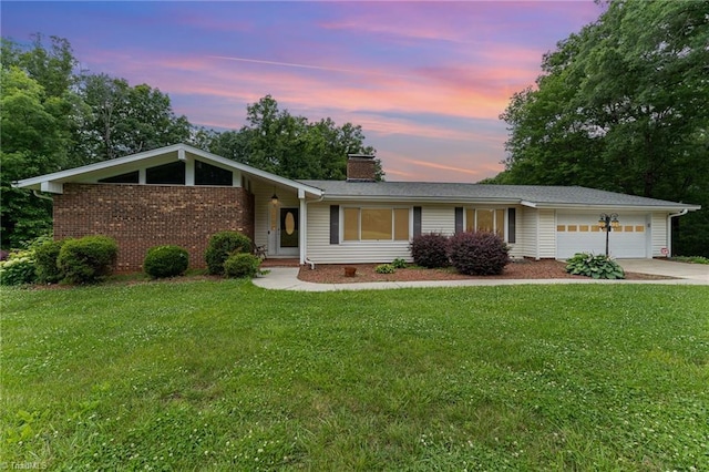 657 Spring St, Walnut Cove, NC 27052 - view of front of house with a chimney, an attached garage, concrete driveway, a lawn, and brick siding