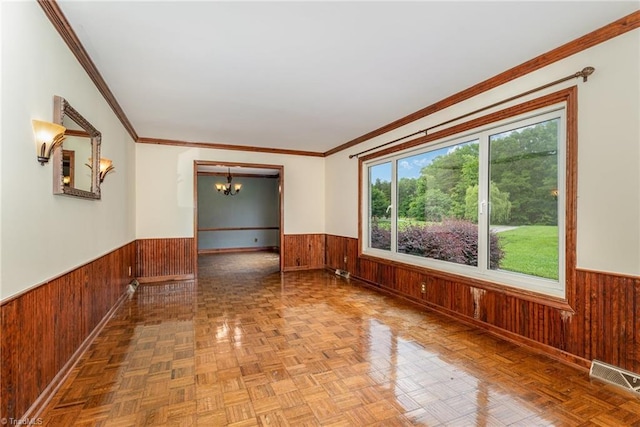 657 Spring St, Walnut Cove, NC 27052 - empty room featuring wainscoting, wooden walls, a chandelier, and ornamental molding