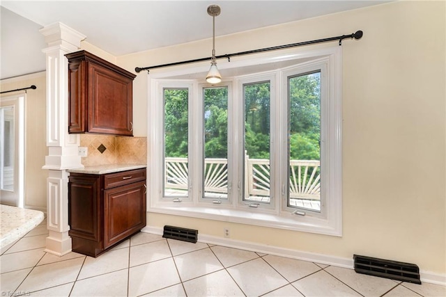 657 Spring St, Walnut Cove, NC 27052 - kitchen featuring plenty of natural light, tasteful backsplash, decorative light fixtures, and light tile patterned floors