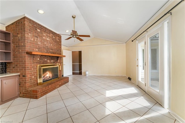 657 Spring St, Walnut Cove, NC 27052 - unfurnished living room featuring vaulted ceiling, a brick fireplace, light tile patterned floors, ceiling fan, and baseboards