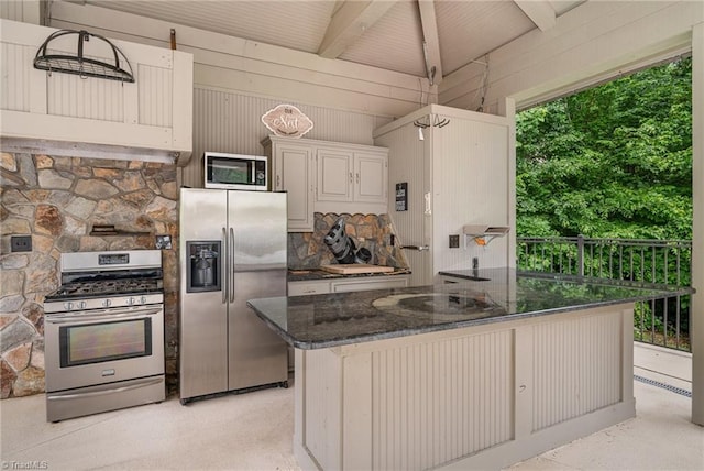 657 Spring St, Walnut Cove, NC 27052 - kitchen with appliances with stainless steel finishes, beam ceiling, dark stone counters, and wooden walls