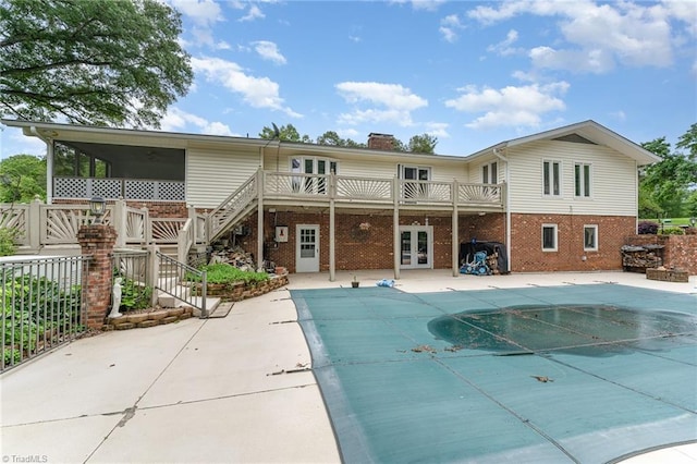 657 Spring St, Walnut Cove, NC 27052 - back of house with stairway, brick siding, a patio area, and a chimney