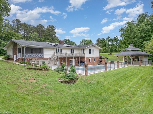 657 Spring St, Walnut Cove, NC 27052 - back of property with a gazebo, brick siding, a chimney, stairway, and a lawn