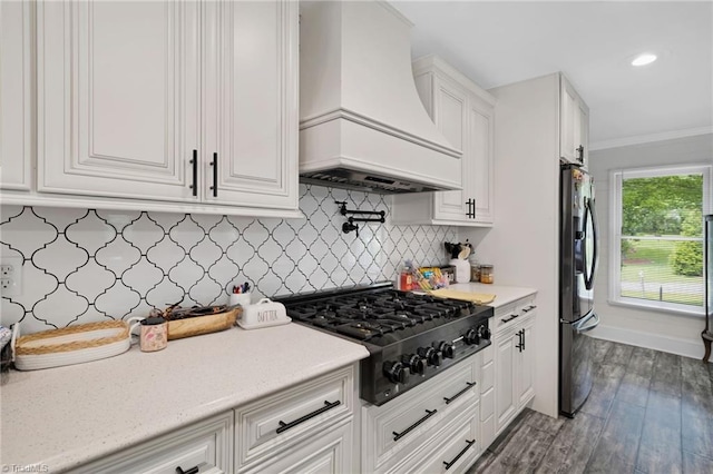 5706 Windworth Dr, Winston-Salem, NC 27106 - kitchen featuring premium range hood, gas stovetop, freestanding refrigerator, white cabinets, and light countertops