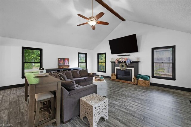 5706 Windworth Dr, Winston-Salem, NC 27106 - living room with a glass covered fireplace, a ceiling fan, beamed ceiling, wood finished floors, and high vaulted ceiling
