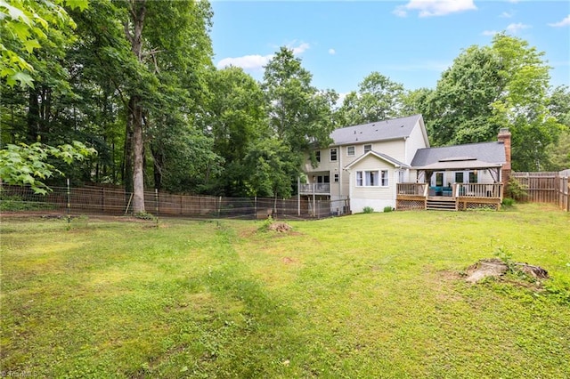 5706 Windworth Dr, Winston-Salem, NC 27106 - rear view of property with a wooden deck, a fenced backyard, and a chimney