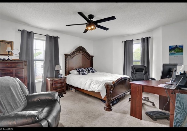 bedroom with ceiling fan, a textured ceiling, and multiple windows