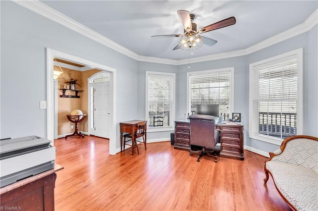 office area with ornamental molding, ceiling fan, light wood-style flooring, and baseboards