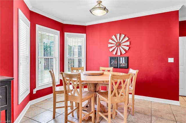 dining room featuring crown molding, baseboards, and light tile patterned floors