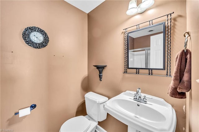 bathroom with toilet and a sink