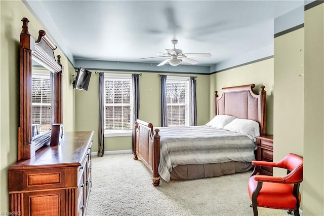 bedroom with light carpet, ceiling fan, and baseboards