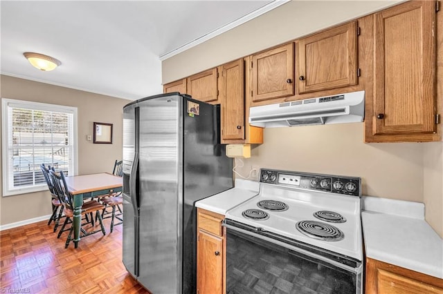 kitchen with under cabinet range hood, stainless steel fridge, light countertops, and electric range oven