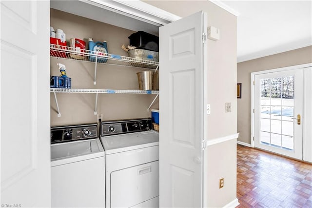 laundry room with baseboards, laundry area, washing machine and clothes dryer, and crown molding