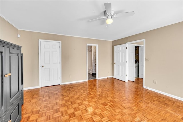 unfurnished bedroom featuring washer / dryer, ceiling fan, baseboards, and crown molding