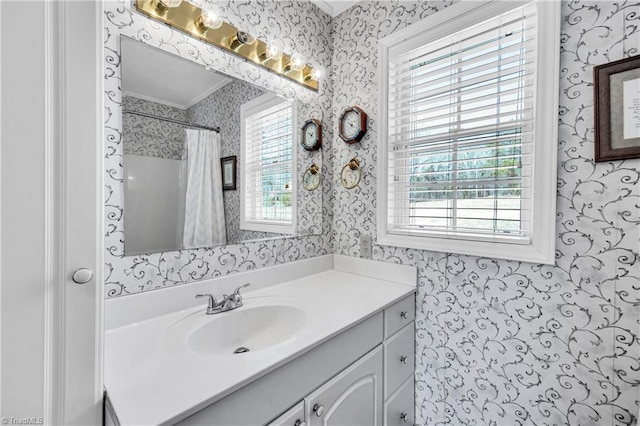 full bathroom featuring a shower with curtain, crown molding, vanity, and wallpapered walls