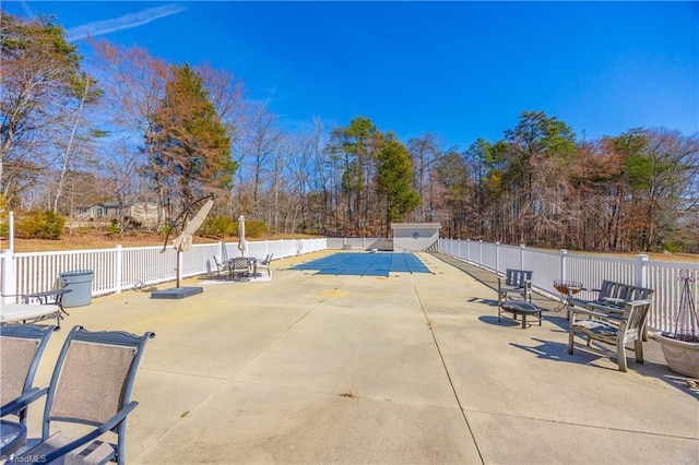 view of pool featuring fence and a patio