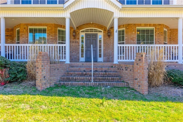 doorway to property with brick siding