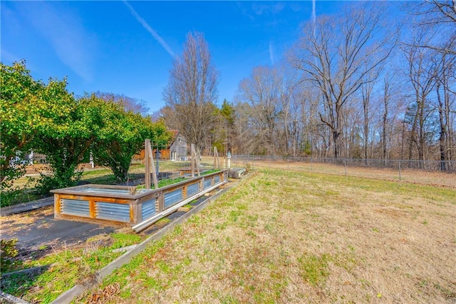 view of yard featuring fence and a rural view