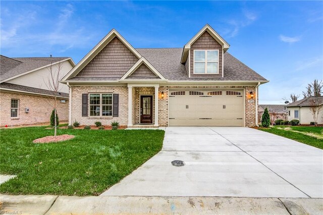 view of front of home with a garage and a front yard