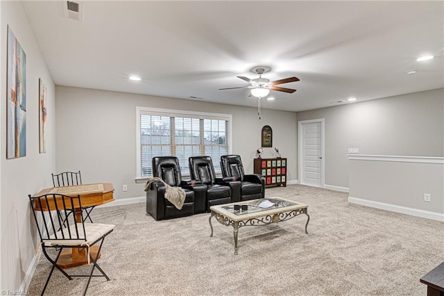 carpeted living room with ceiling fan