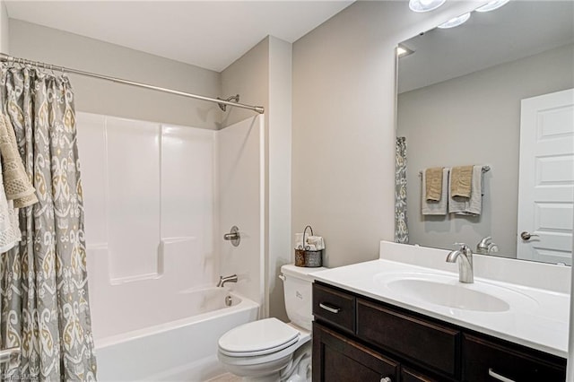 full bathroom with vanity, shower / tub combo, and toilet