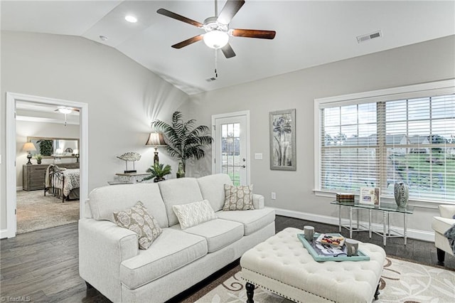 living room featuring ceiling fan, dark wood-type flooring, and vaulted ceiling