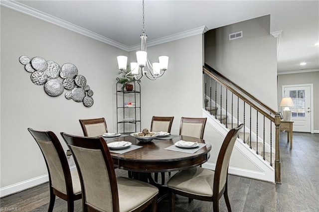 dining area with ornamental molding, an inviting chandelier, and dark wood-type flooring