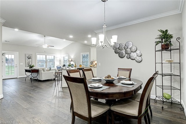 dining space featuring ceiling fan with notable chandelier, lofted ceiling, crown molding, and hardwood / wood-style flooring