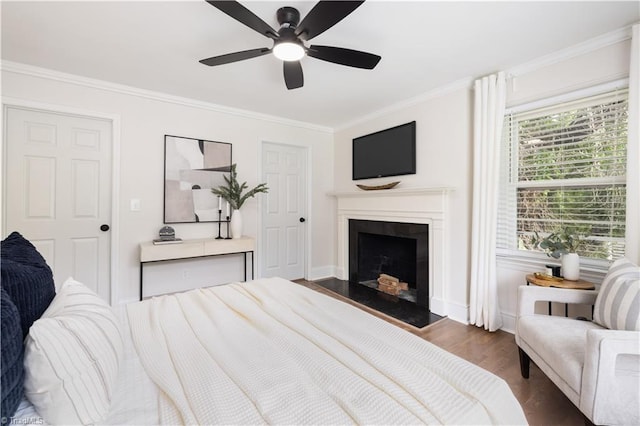 252 Lucerne Ln NW, Winston-Salem, NC 27104 - bedroom with ornamental molding, dark wood-type flooring, a fireplace with flush hearth, baseboards, and a ceiling fan