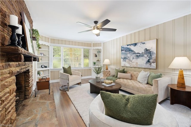 252 Lucerne Ln NW, Winston-Salem, NC 27104 - living area with ornamental molding, wood finished floors, ceiling fan, a stone fireplace, and built in features