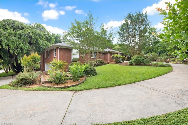 252 Lucerne Ln NW, Winston-Salem, NC 27104 - view of side of property featuring a yard, brick siding, concrete driveway, and a garage